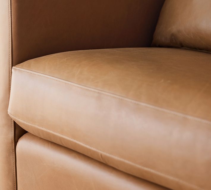 Close-up of tan leather seat cushion with stitching