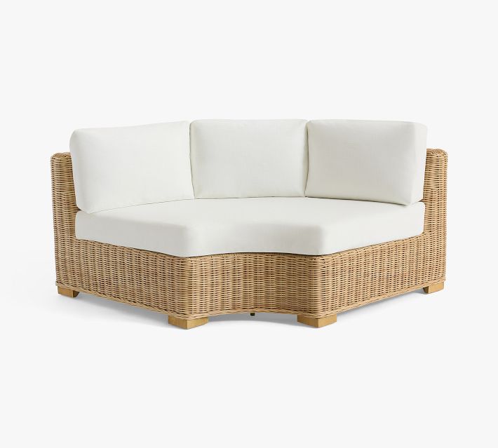 Product image: curved wicker sofa with white cushions and low back.