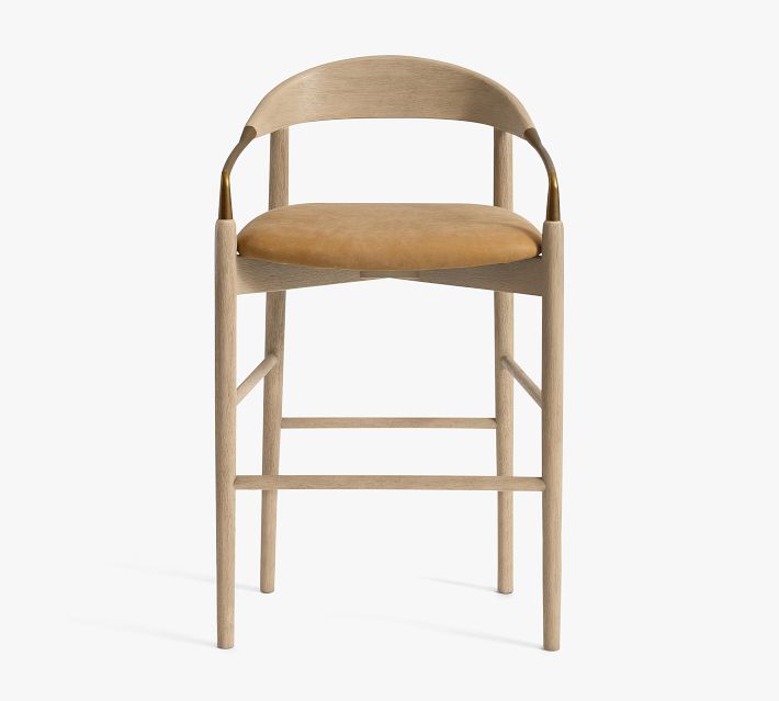 Front view of bar stool with brass accent and light wood frame