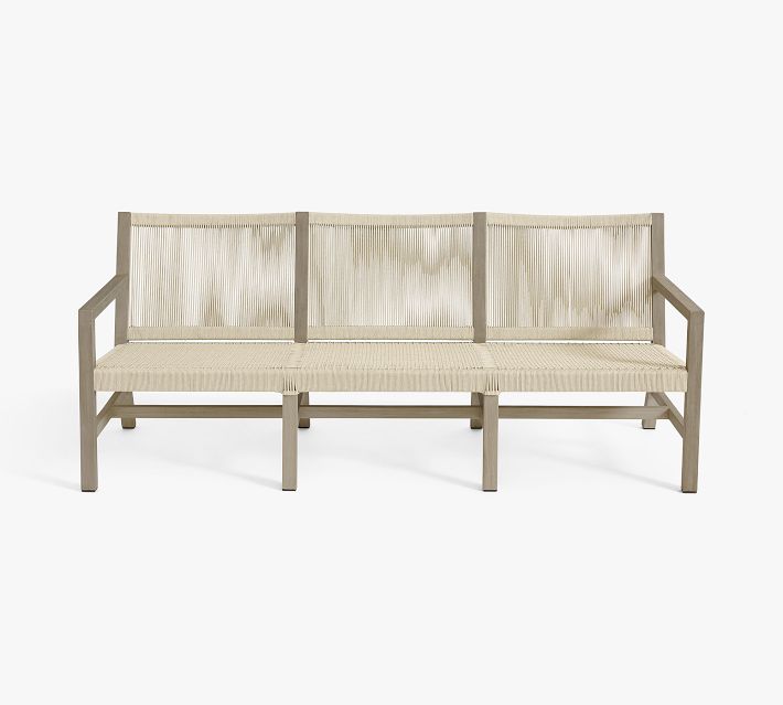 Three-seat sofa close-up of woven back panels and wooden frame.