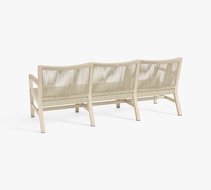 Three-seat outdoor sofa with woven back panels viewed from the rear.