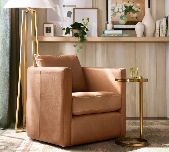 Tan leather chair with side table and decor