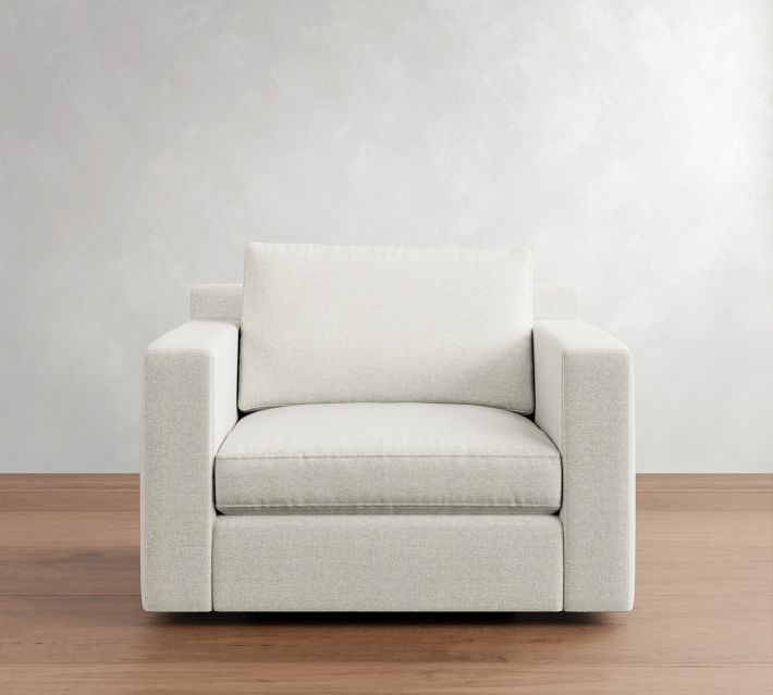 Front view of a beige armchair with a large back cushion and arms.