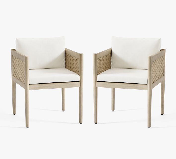 Two matching armchairs facing forward with cushions