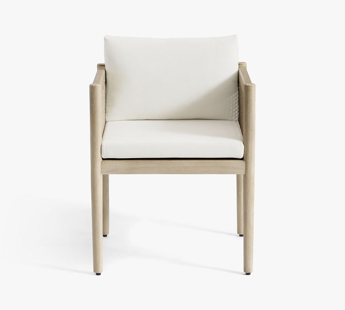 Single armchair with cream cushion and light wood frame