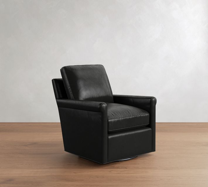 Three-quarter view of a black leather armchair with a curved lower front and side, revealing the sofa’s depth and curved edges.