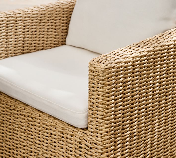 Close-up of the wicker armrest and cushion on the wicker chair