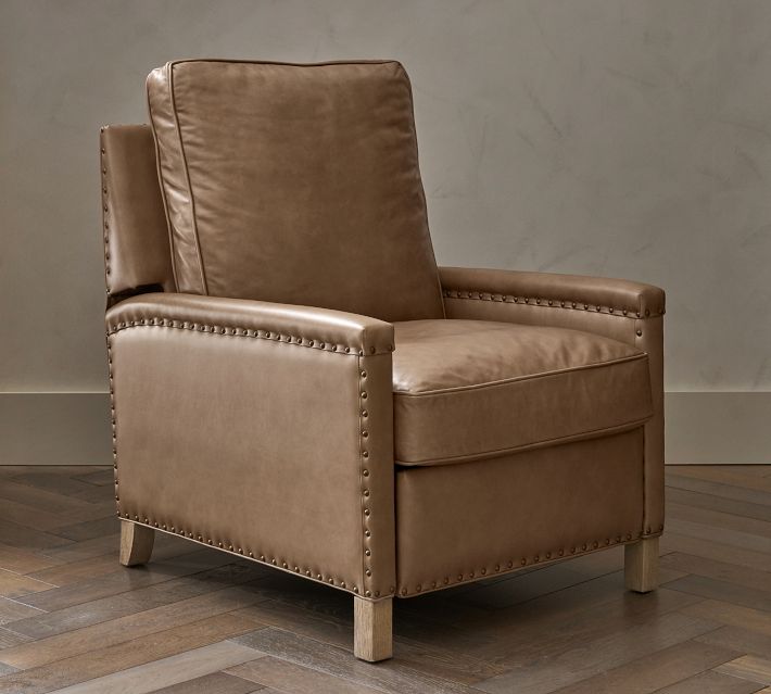 Brown leather chair with a tall back and metal studs along edges.