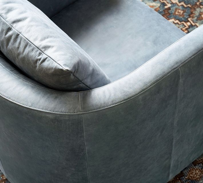 Close-up of blue velvet upholstery on armchair curved edge