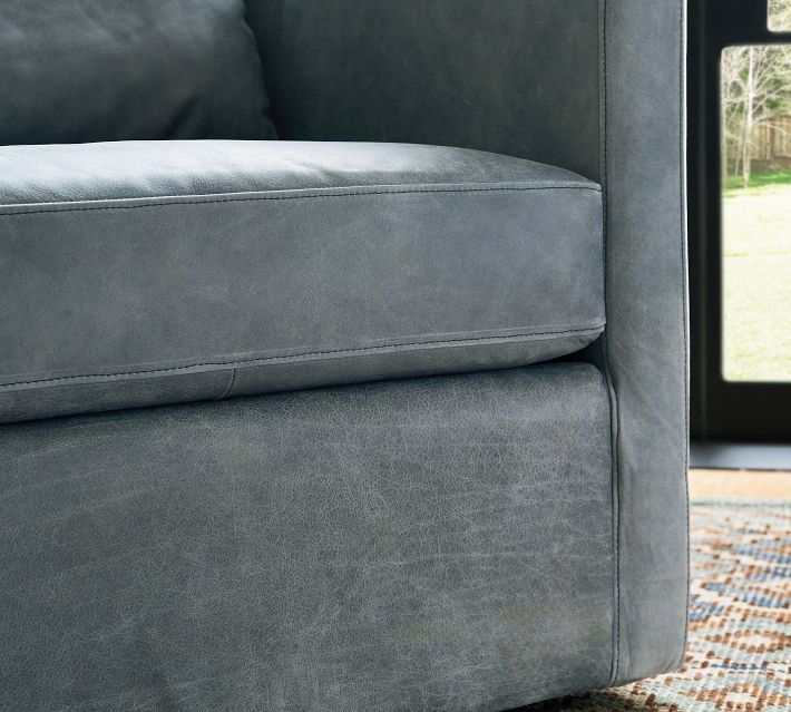 Blue velvet armchair with window beside