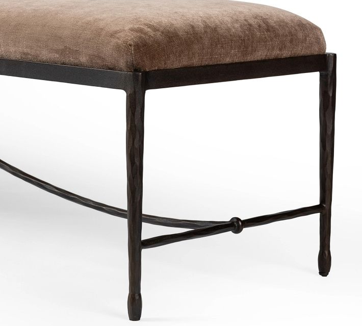 Corner view of the bench with the cushion and metal frame visible, highlighting construction and finish.