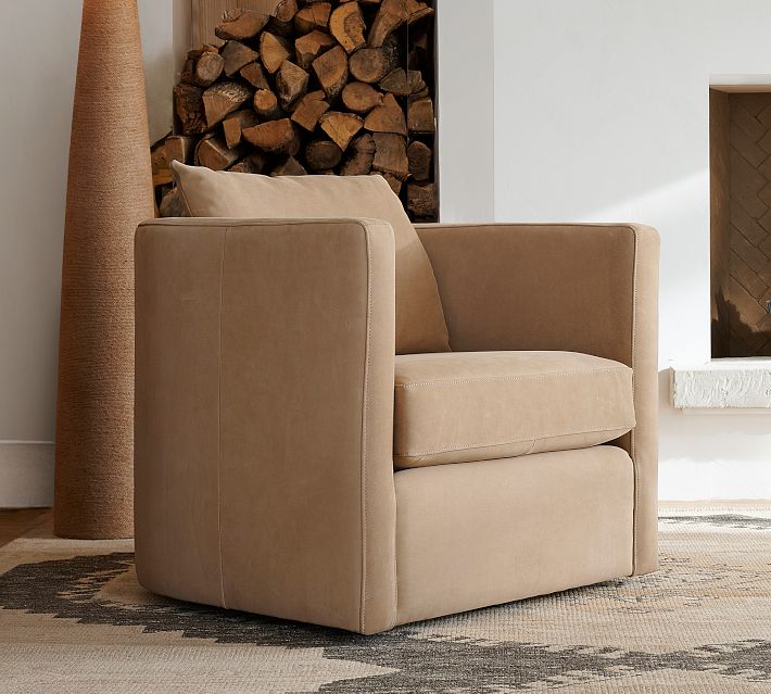 Living room with tan armchair, fireplace, and wood storage