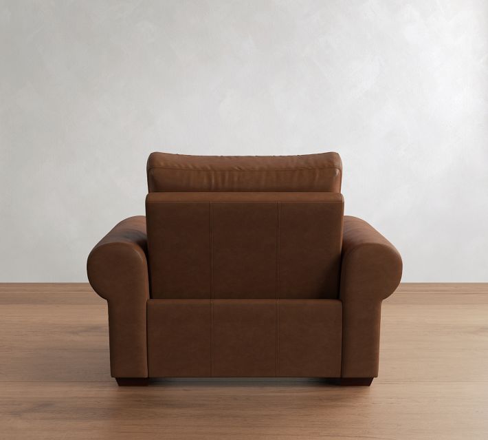 Back view of the same brown leather armchair with headrest visible.