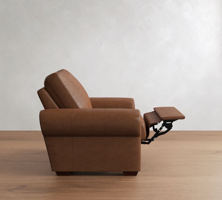 Extended footrest of the brown leather armchair in reclined position.