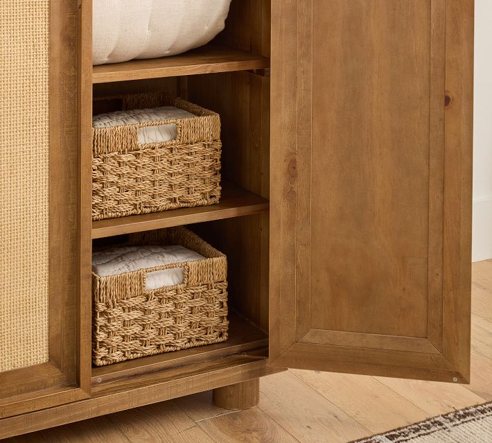Shelf area with woven baskets inside cabinet.