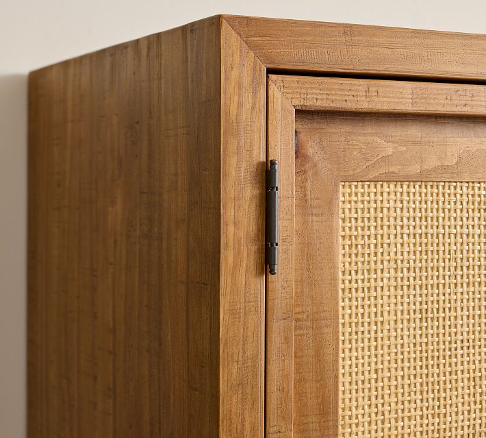 Close-up of wooden frame and hinges on woven panel door.