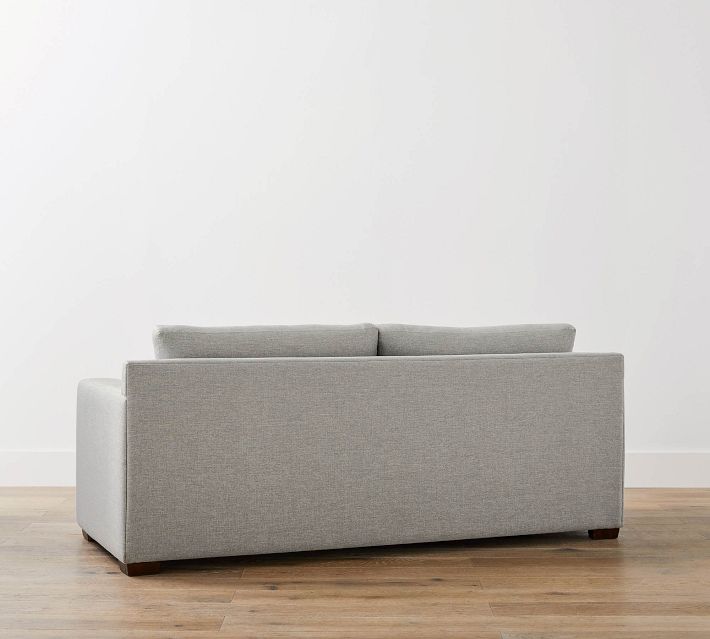 Back view of gray sofa showing long back and cushions