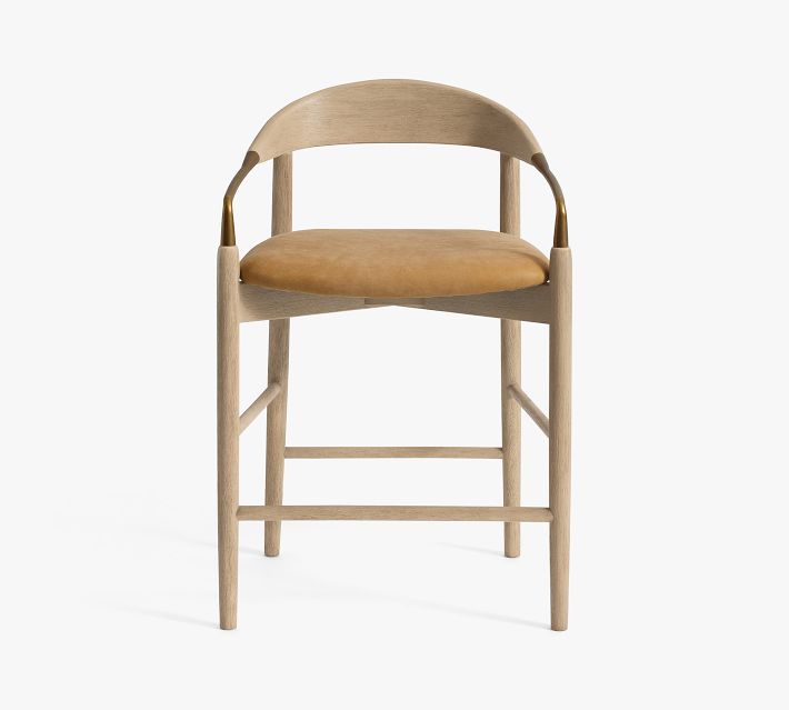 Full view of bar stool with light wood frame and tan cushion