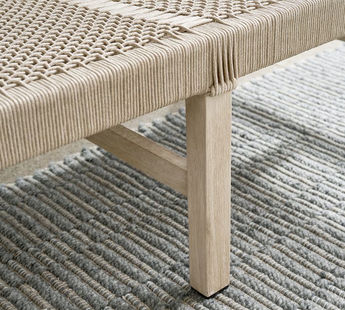 Side view of a wooden outdoor chair leg and frame, showing light natural wood finish.